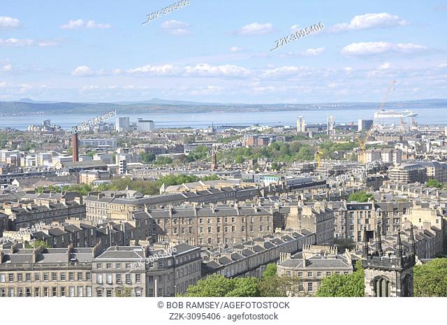 View on the roofs of the city of Edinburg and the sea in Scotland
