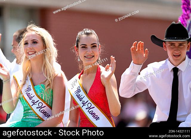Buckhannon, West Virginia, USA - May 18, 2019: Strawberry Festival, Beauty Contestants, on float, going down Main Street, smiling, waving at spectators