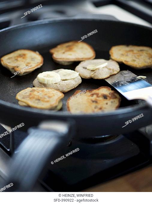 Frying banana pancakes in a frying pan