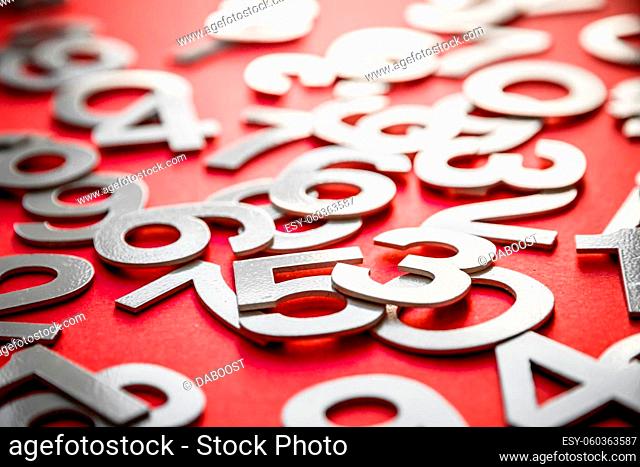 Mathematics background made with solid numbers on a board. Isolated on red