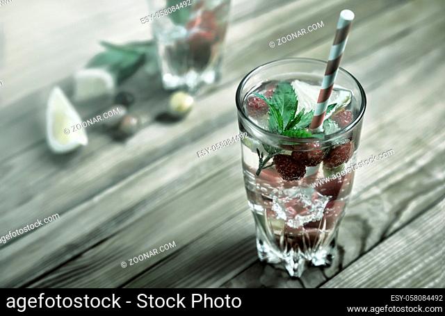 Summer Refreshing cocktail of natural fruits and various berries with ice and mint leaves infused with water. Contains lemon, raspberry, cherry, gooseberry