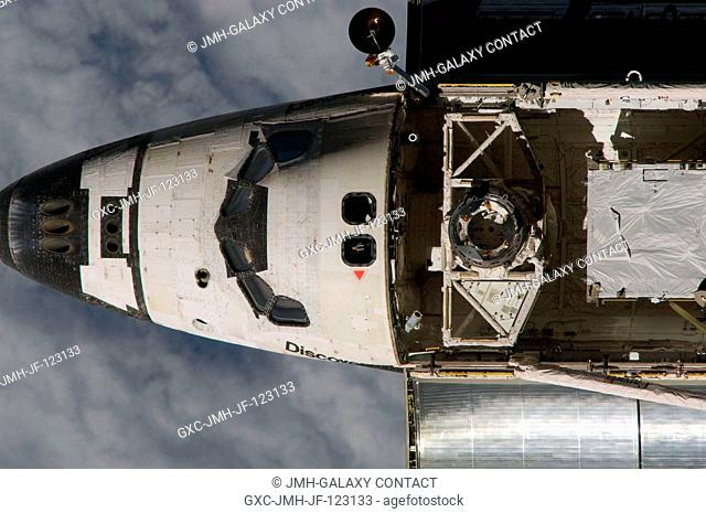 An overhead view of the exterior of Space Shuttle Discovery's crew cabin, part of its payload bay and docking system was provided by Expedition 18 crewmembers...