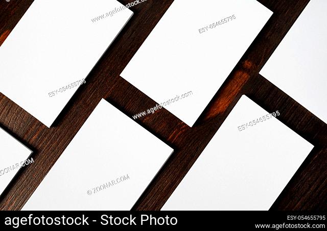 Blank business cards on wood table background. Mockup for branding identity. Flat lay