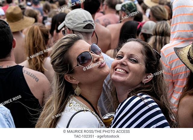 Two fans in the crowd at the Tortuga Music Festival in Fort Lauderdale Florida on April 16, 2016