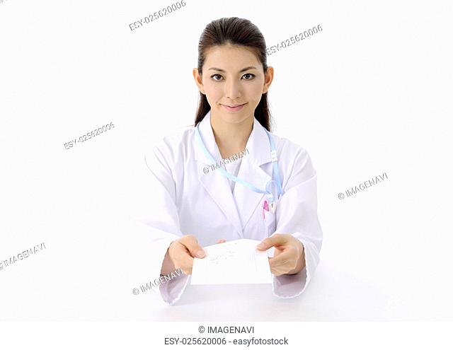 Pharmacist holding out an envelope for drug