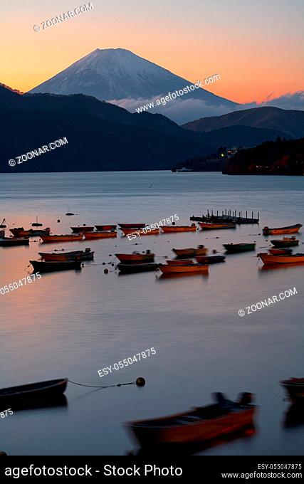 The view of boats in the harbor of Lake Ashinoko with Mount Fuji on the background at the sunset. Kanagawa. Honshu. Japan