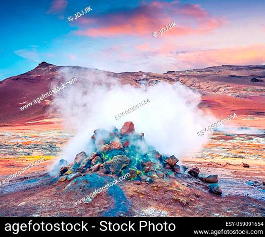 Steaming fumarole in geothermal valley Hverarond. Exotic summer sunrise of volcanic Icelandic landmark, Reykjahlid village location, north Iceland, Europe