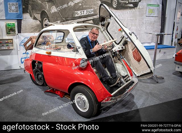 31 January 2020, Bremen: Hoka Leverenz, member of the Isetta Club, sits in a BMW Isetta at the Bremen Classic Motorshow. On an area of almost 50