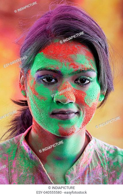 Woman's face covered in holi colours