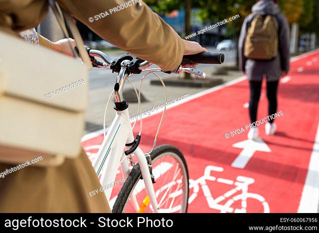 close up of cyclist behind pedestrian on bike lane