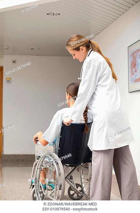 Doctor pushing a wheelchair
