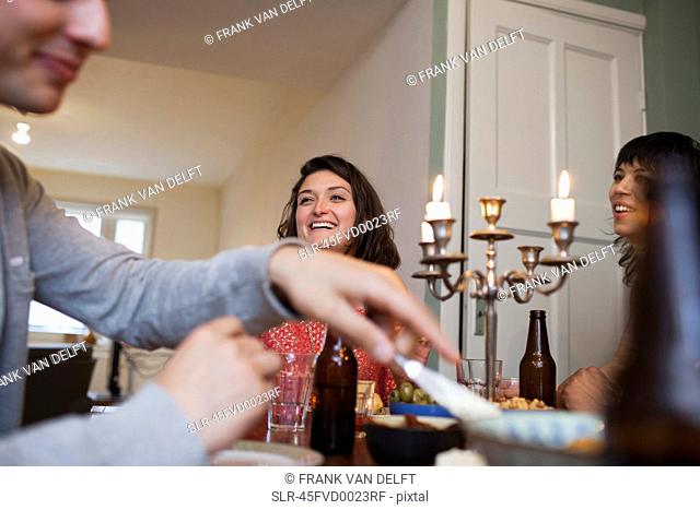 Friends talking at dinner table
