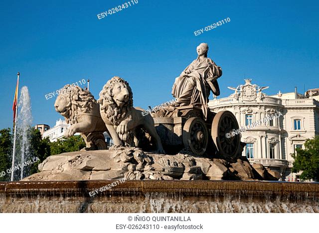 landmark of famous neoclassical sculpture monument fountain of greek goddess Cibeles pulled by lions in Madrid city Spain Europe, with water falling