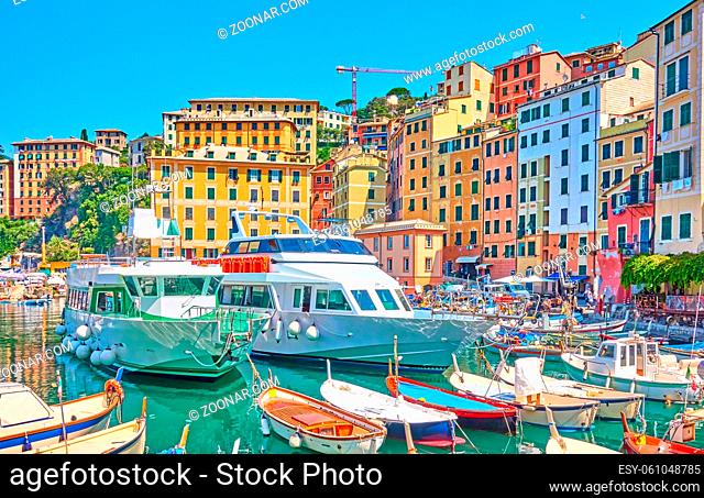 Boats and ships in the port of Camogli town on sunny summer day, Genoa, Italy