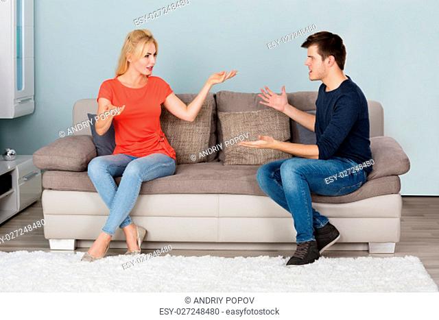 Sad Stressed Couple On Couch Quarreling About Infidelity With Each Other At Home