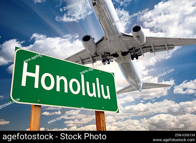 Honolulu Green Road Sign and Airplane Above with Dramatic Blue Sky and Clouds
