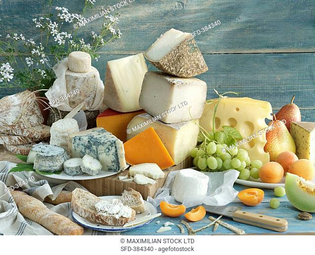 An arrangement of various cheeses, grapes and pears