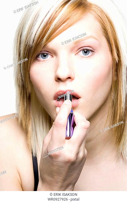 Close-up of woman applying make up