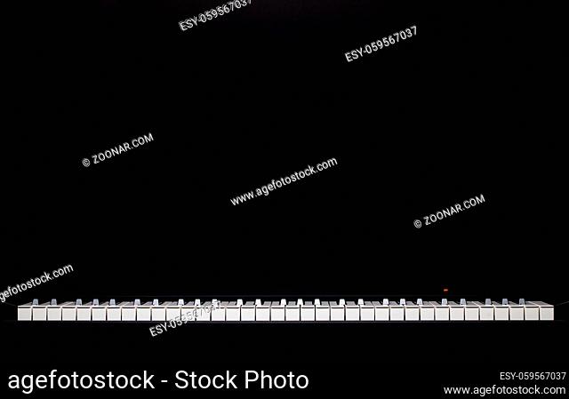 The silhouette of grand piano in the dark room. Piano keyboard. Music instrument. Black and white key. Play sound, chord, melody