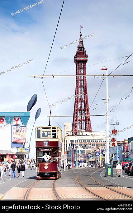 General view looking along the Promenade from the south, with a tram approaching and Blackpool Tower in the background, Blackpool, Lancashire, UK