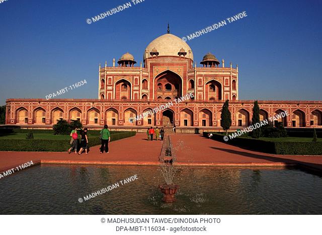 Tourists at Humayun's tomb built in 1570 made from red sandstone and white marble first garden-tomb on Indian subcontinent persian influence in mughal...
