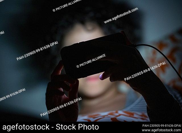 PRODUCTION - 01 September 2023, Berlin: A woman is watching a program on a smartphone in a bed. Photo: Sebastian Christoph Gollnow/dpa