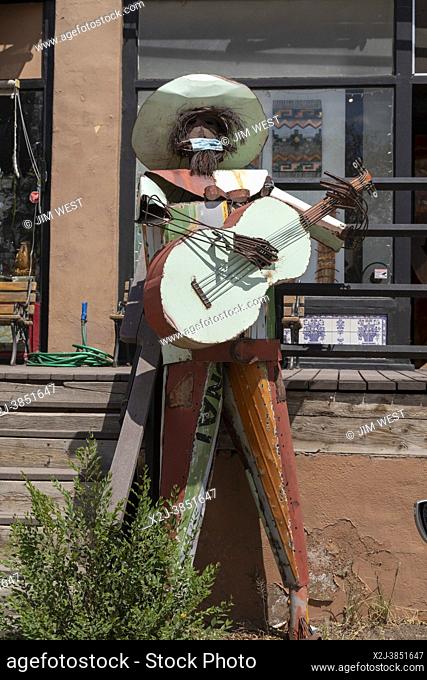 Madrid, New Mexico - Sculpture of a guitar player wearing a coronavirus mask in a small town filled with art shops and other tourist attractions on the...