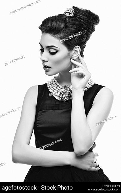 beautiful young woman in retro style dress and accessories. studio shot isolated on white background. copy space