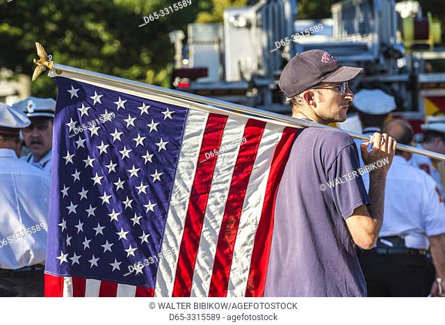 USA, New England, Massachusetts, Cape Ann, Rockport, Rockport Fourth of July Parade, young man with US flag, NR