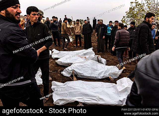 25 November 2023, Syria, Qoqfin: People bury the victims who were killed as a result of artillery shelling by the Syrian regime on the village of Qoqfin