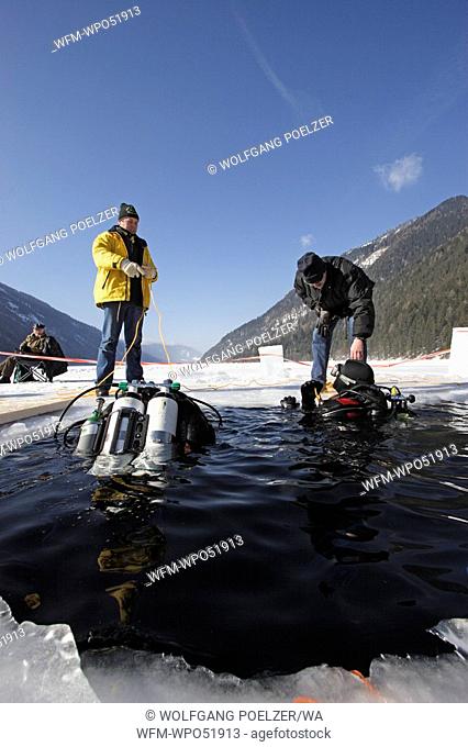 Ice-Diver at Surface of frozen Lake, Lake Weissensee, Carinthia, Austria
