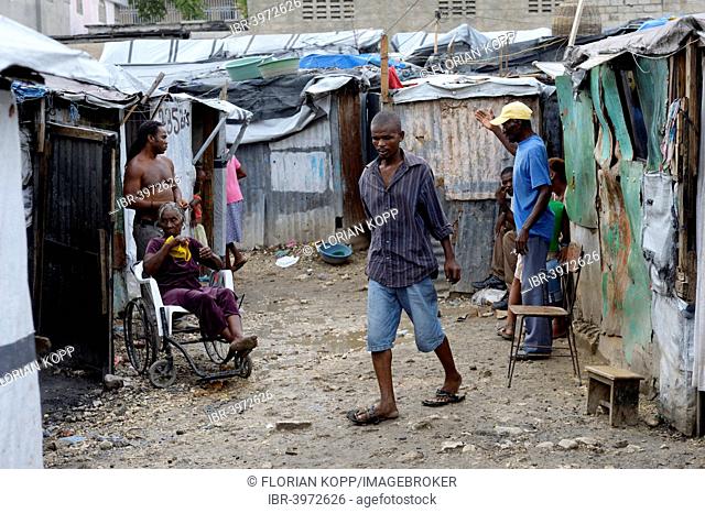 People and a sick woman in a wheelchair, Camp Icare, camp for earthquake refugees, Fort National, Port-au-Prince, Haiti