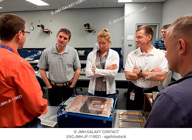 STS-135 crew members participate in an Animal Enclosure Module (AEM) training session in the Jake Garn Simulation and Training Facility at NASA's Johnson Space...