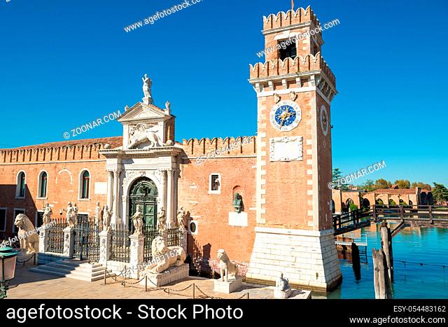 Facade of Venetian Arsenal with tower, gate and statues. Venice, Italy