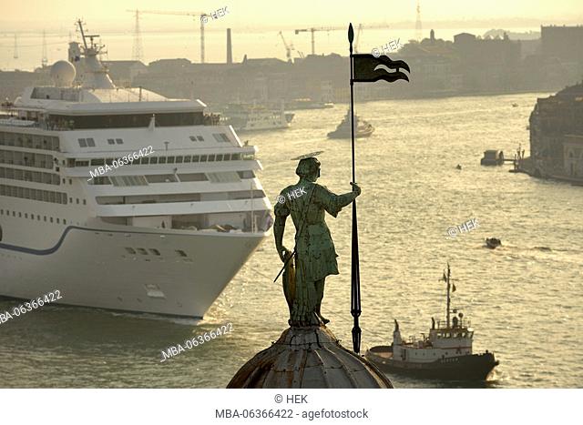 A cruiser drives passes the statue of St. George on the Palladian Basilica in Venice