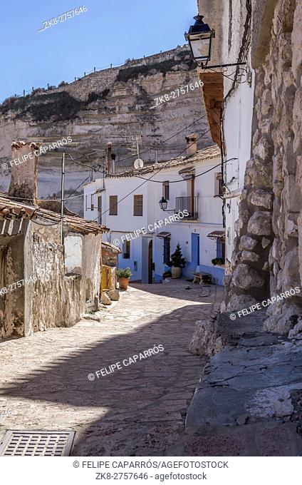 Narrow street with white painted houses, typical of this town, take in Alcala of the Jucar, Albacete province, Spain