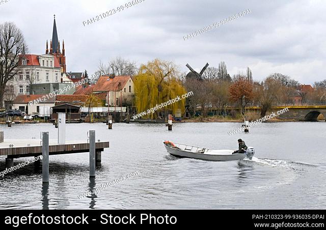 23 March 2021, Brandenburg, Werder (Havel): A fisherman transports young eels to their destination on the Havel. The stocking operations are necessary because...