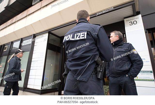 Policemen standing in front of the building after a shooting in a medical practice in Marburg, Germany, 15 December 2016