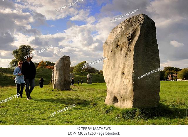England, Wiltshire, Avebury. Tourists visiting the Avebury ring, the oldest stone ring known to be in existence in the world