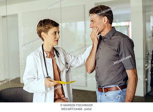 Female doctor calming worried patient