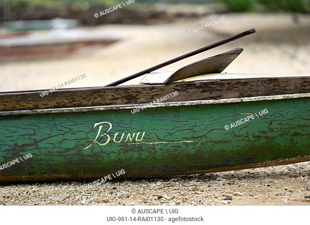 Weathered side of a green-painted canoe hauled up on beach. Kwato Island near Samarai Island, Milne Bay Province, Papua New Guinea