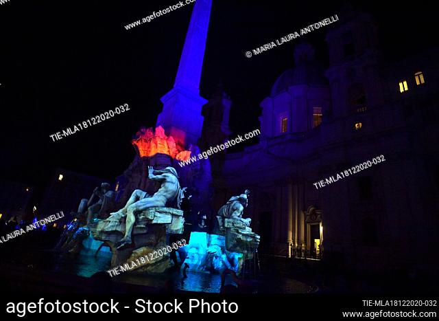 The Fontana dei quattro fiumi (Fountain of the four rivers) in Piazza Navona illuminated with light shows each night for the duration of the Christmas season