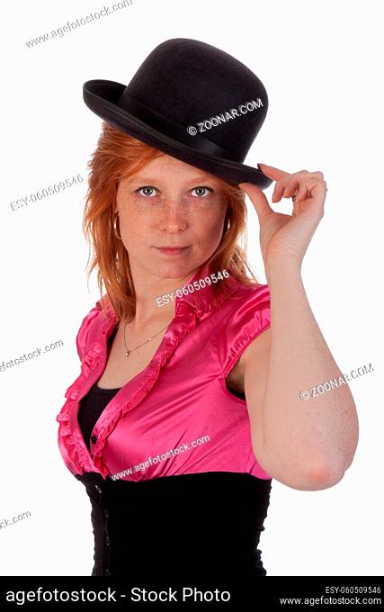Pretty redhear girl in a pink blouse with a bowler