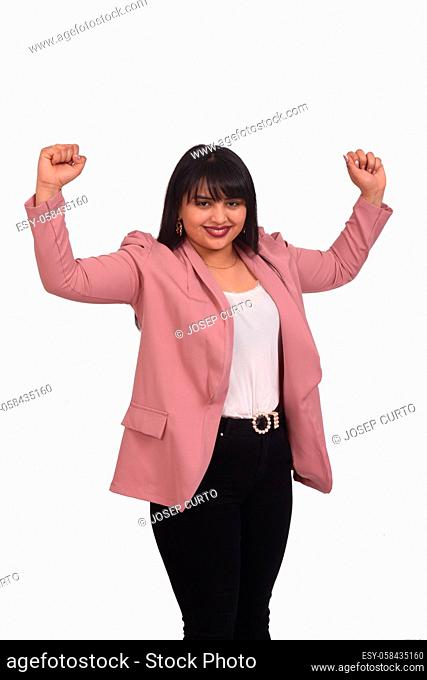 portrait of a woman raising her arms and smiling in victory sign on white background