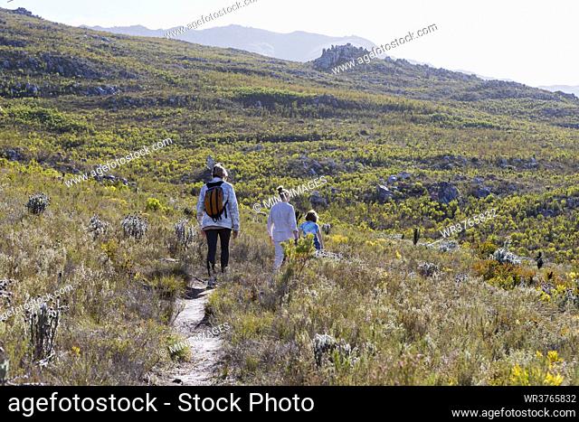 Family hiking a nature trail, Phillipskop nature reserve, Stanford, South Africa