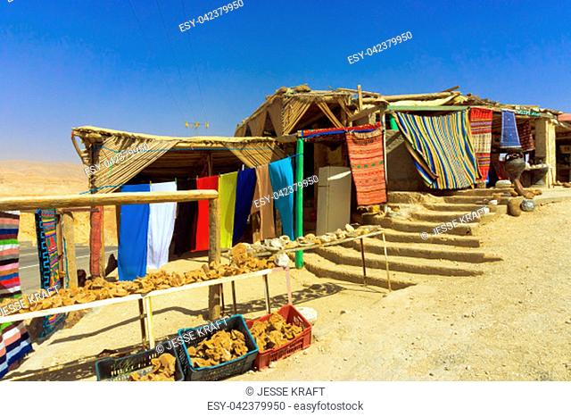 Stores selling souvenirs in the desert with colorful rugs and scarves in the area of Ong Jemel, Tunisia