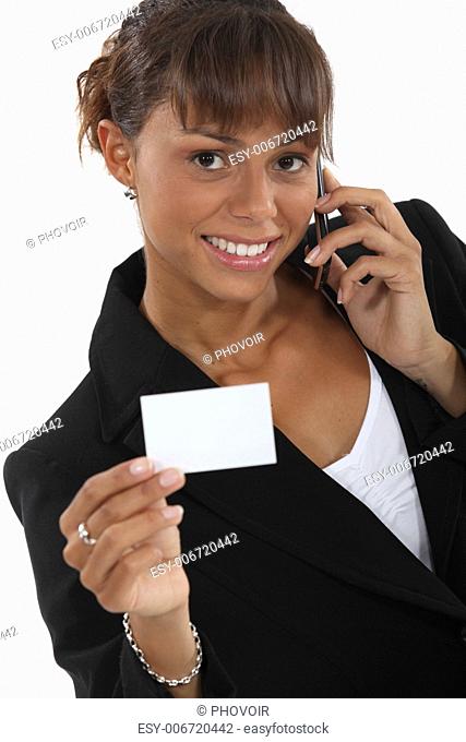 Woman calling number on business-card