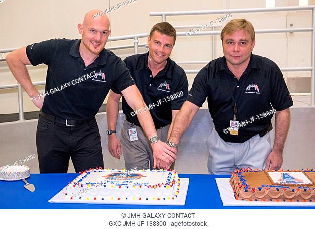 At cake cutting time for the Expedition 41 crew in the space station training facility (SSTF), from the left, Alexander Gerst of the European Space Agency