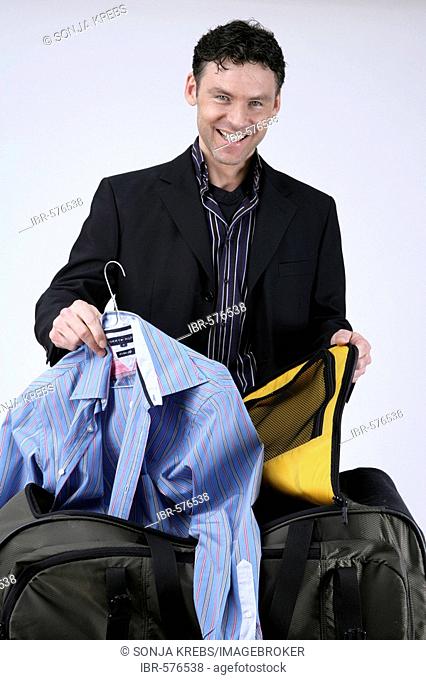 Man packing travelling bag