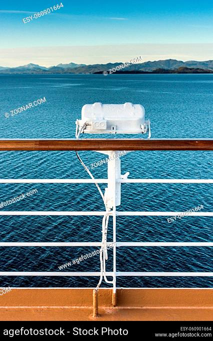 White metal marine exterior light fixture on railing of cruise ship, early morning, Alaska Inside Passage route